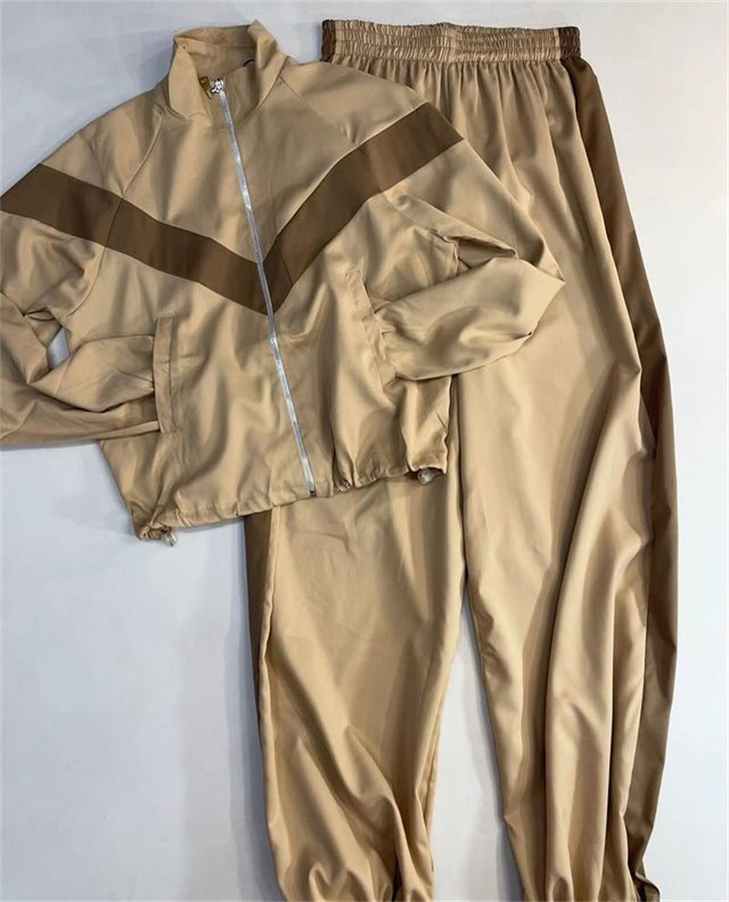 Detail view showing the smooth satin fabric of the women's track suit