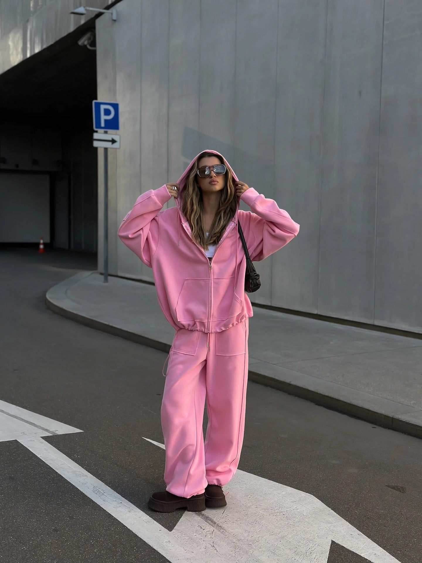Full-length view of a women's oversized hooded jacket
