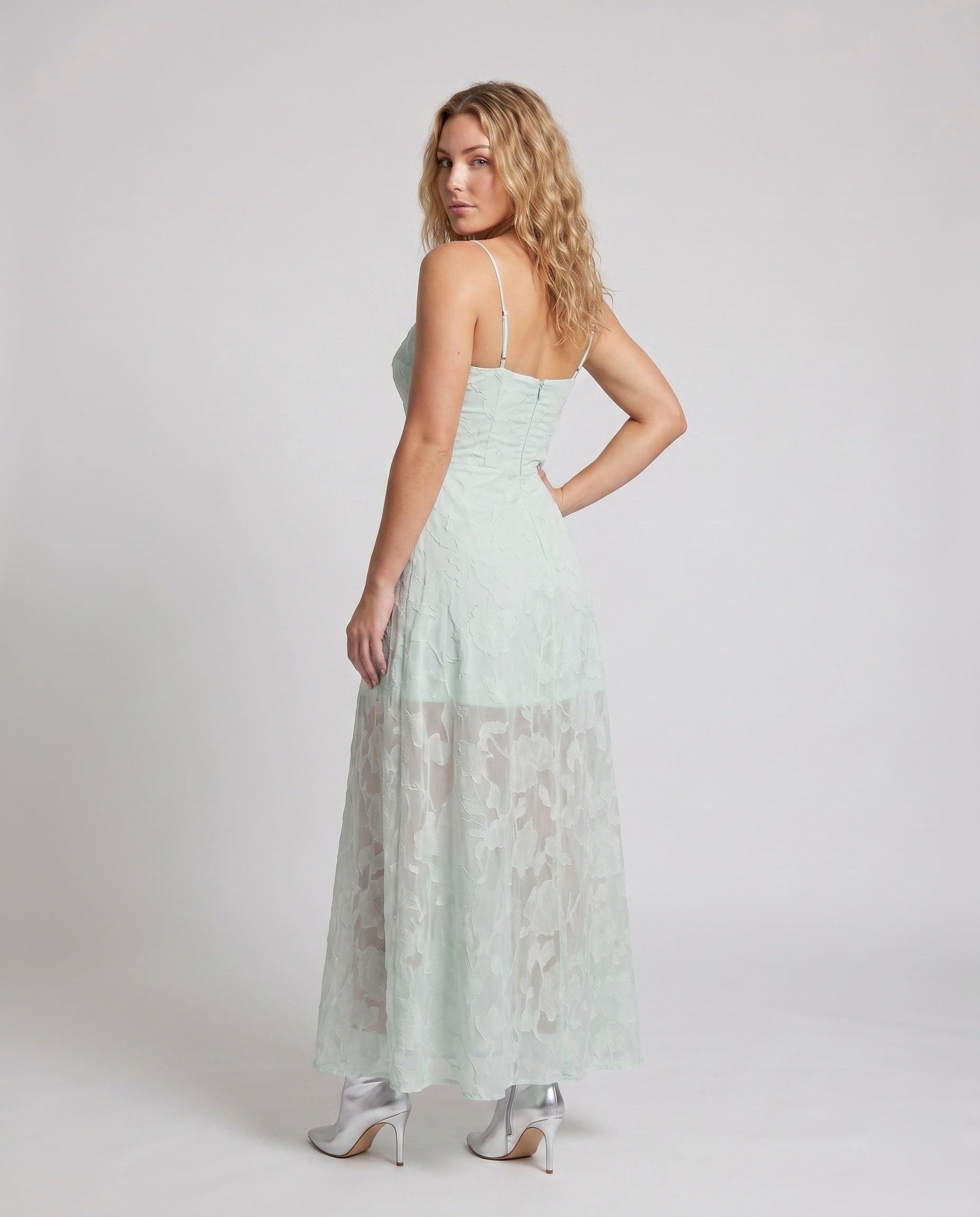 Back view of a lace bridal gown with sheer detailing