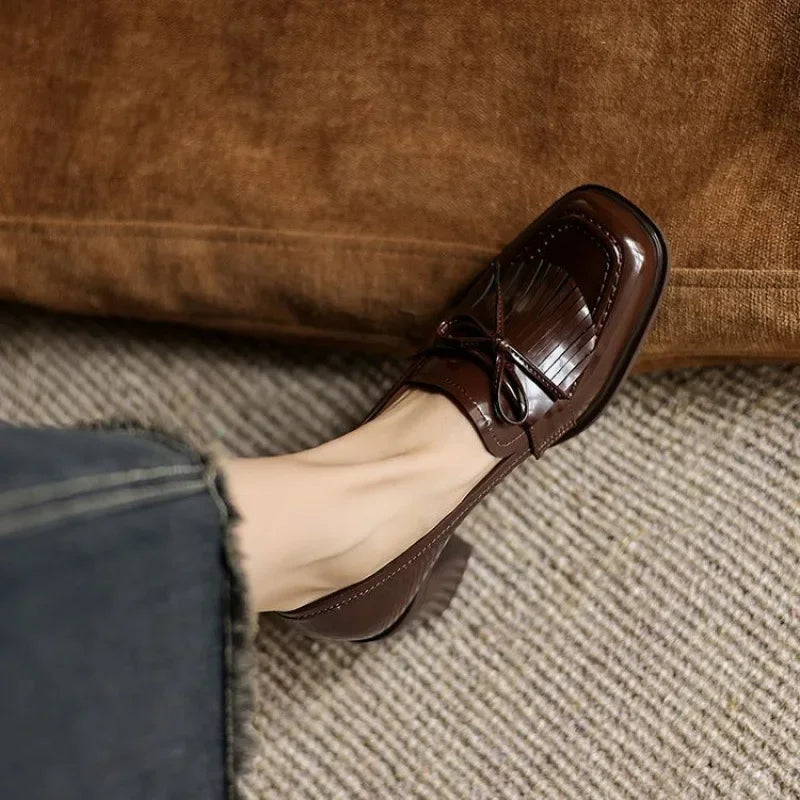 Back view of women's heeled loafers showing the heel shape