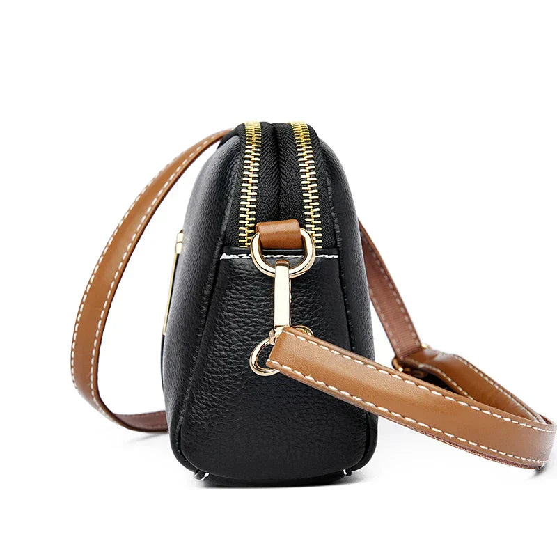 Close-up of faux leather texture, hardware, and handle details on the handbag
