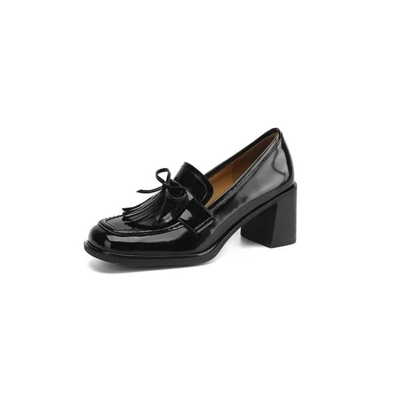 Women's heeled loafers angled to show the rounded toe