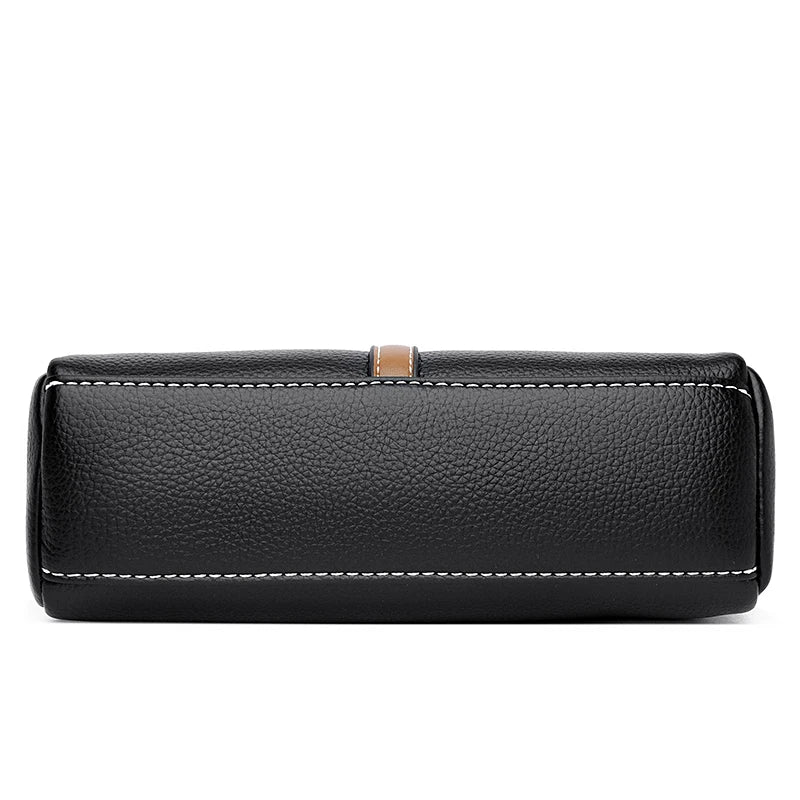 Faux leather handbag styled to show top handles, zipper closure, and shoulder strap