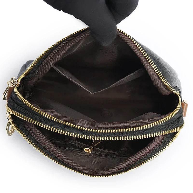 Open women's handbag showing interior organizer and multiple compartments