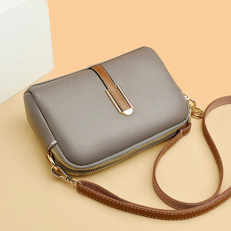 Side view of the women's faux leather handbag with structured silhouette