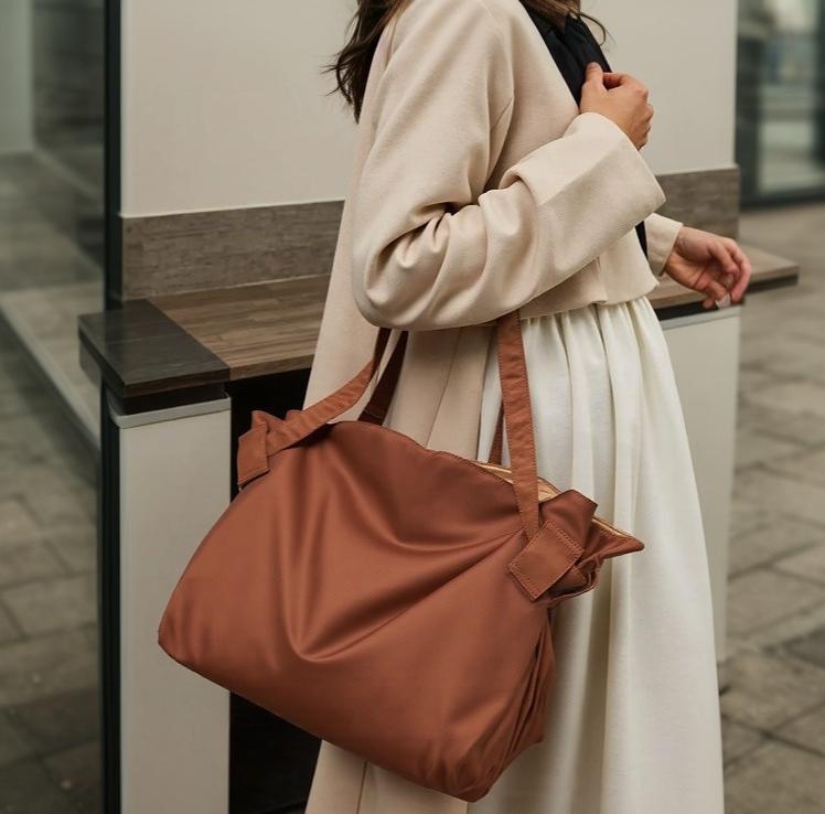 Tote bag with shoulder straps displayed on a plain background