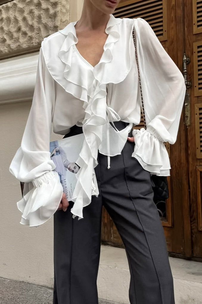 Back view of the women's blouse with long sleeves