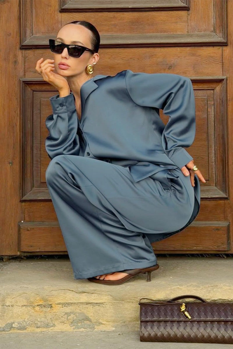 Detail of the satin shirt front with buttons and a classic collar