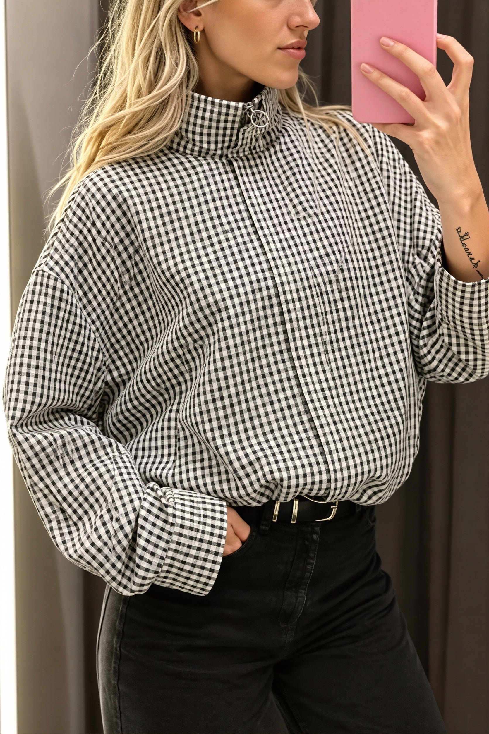 Cropped bomber jacket showing its gingham pattern and structured collar