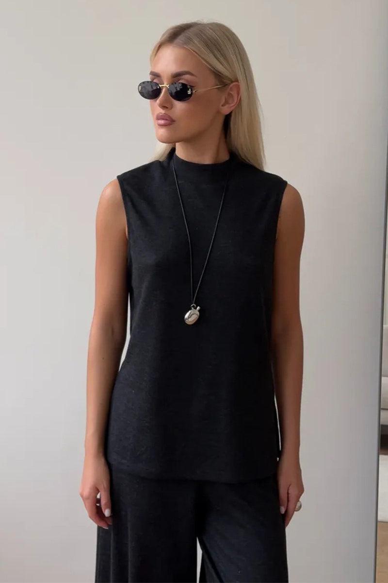Side view of the sleeveless top and flowing wide-leg pants