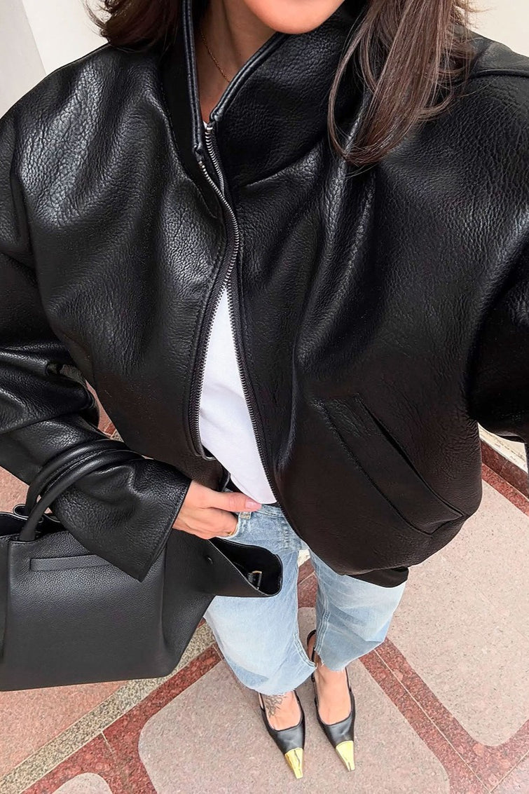 Back view of the cropped faux leather jacket with a clean, structured design