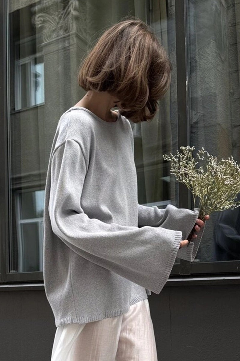 Knit sweater shown from the back with an open-back design