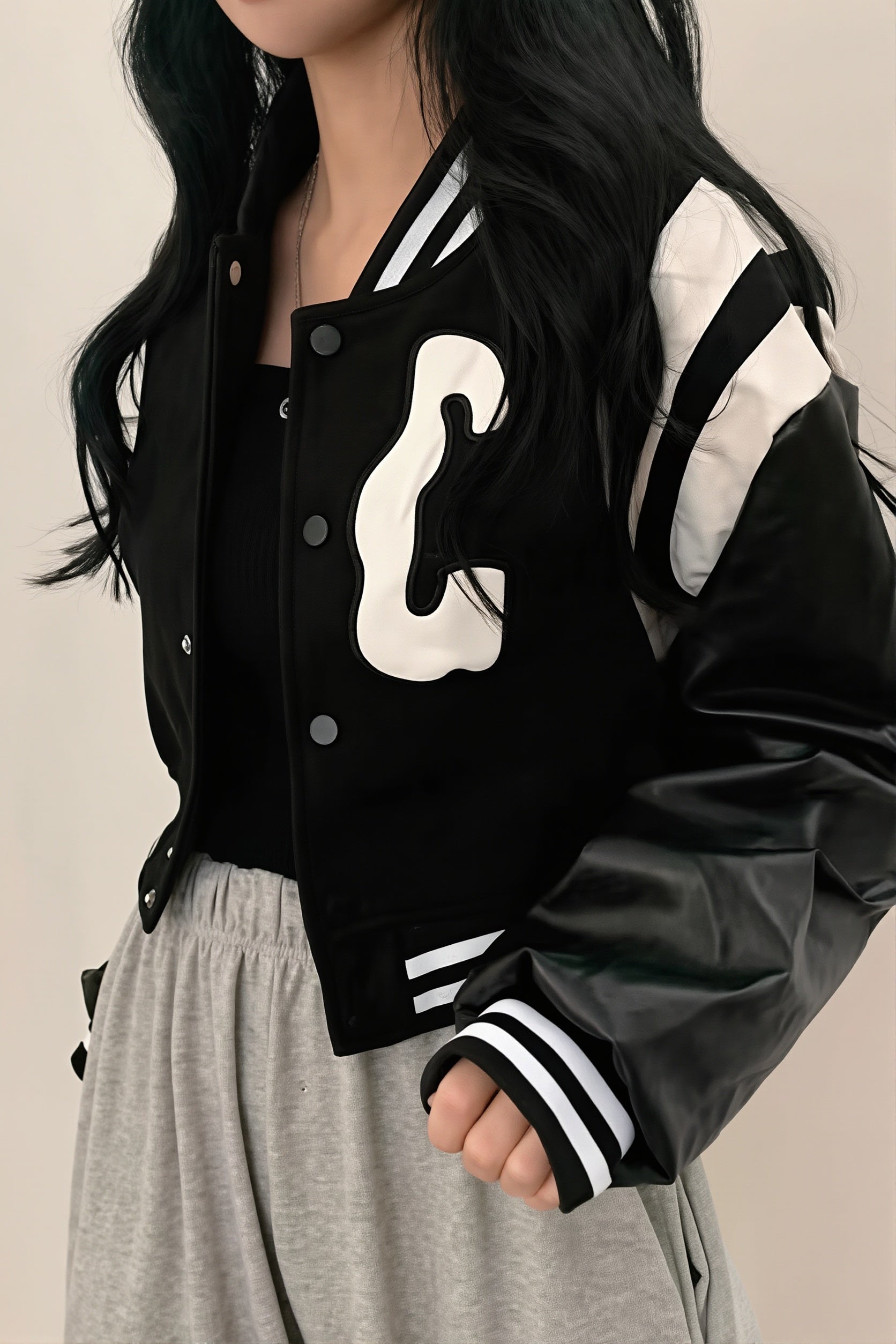 Cropped letter patch varsity jacket styled as a casual outer layer