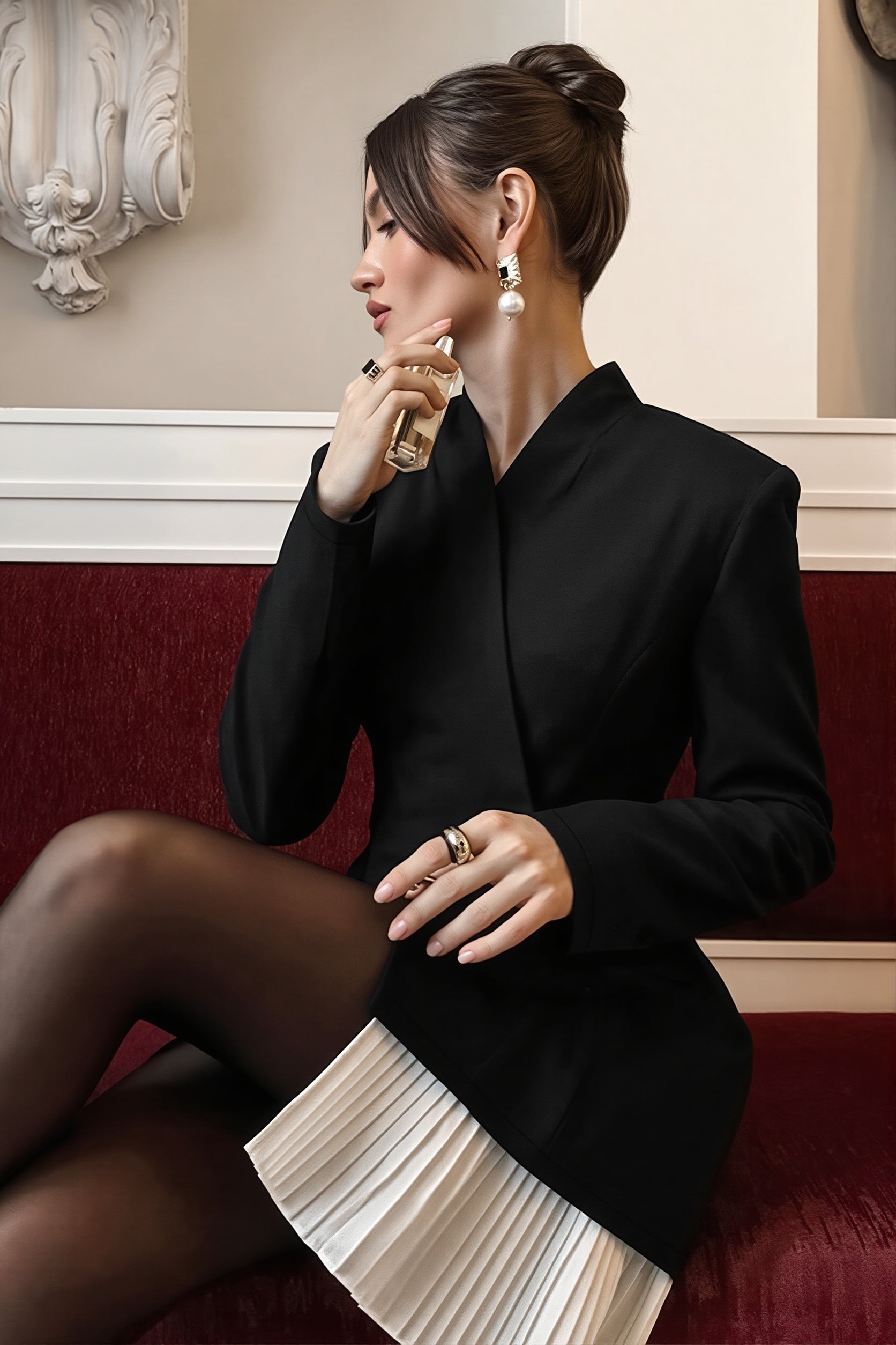 Detailed view of the pleated hem on the blazer dress