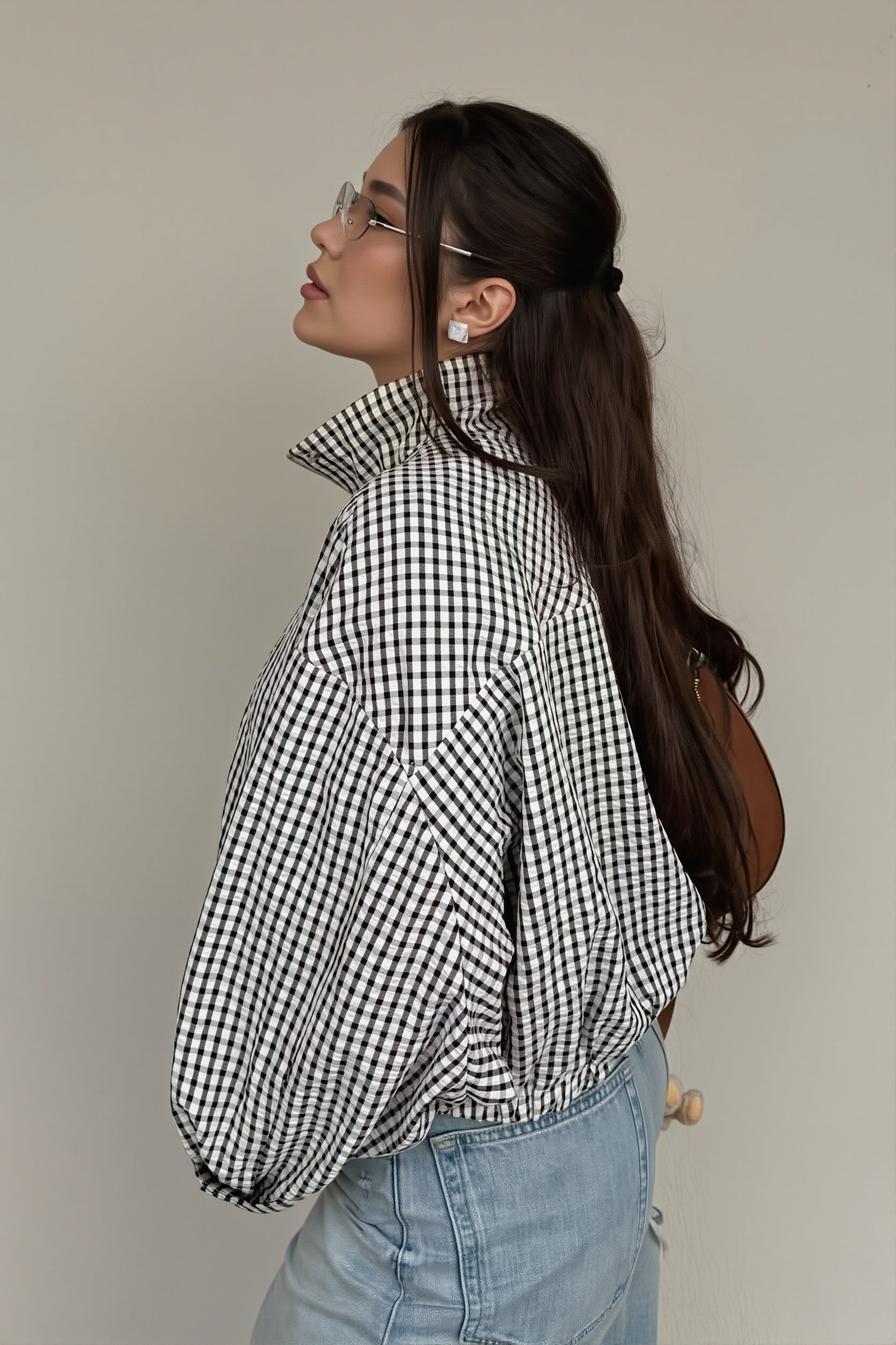Close-up of the stand collar and front zip on the gingham jacket
