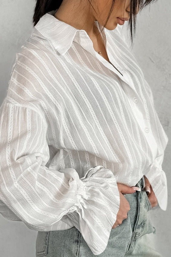 Sheer stripe shirt styled with the sleeves and ruffle cuffs visible