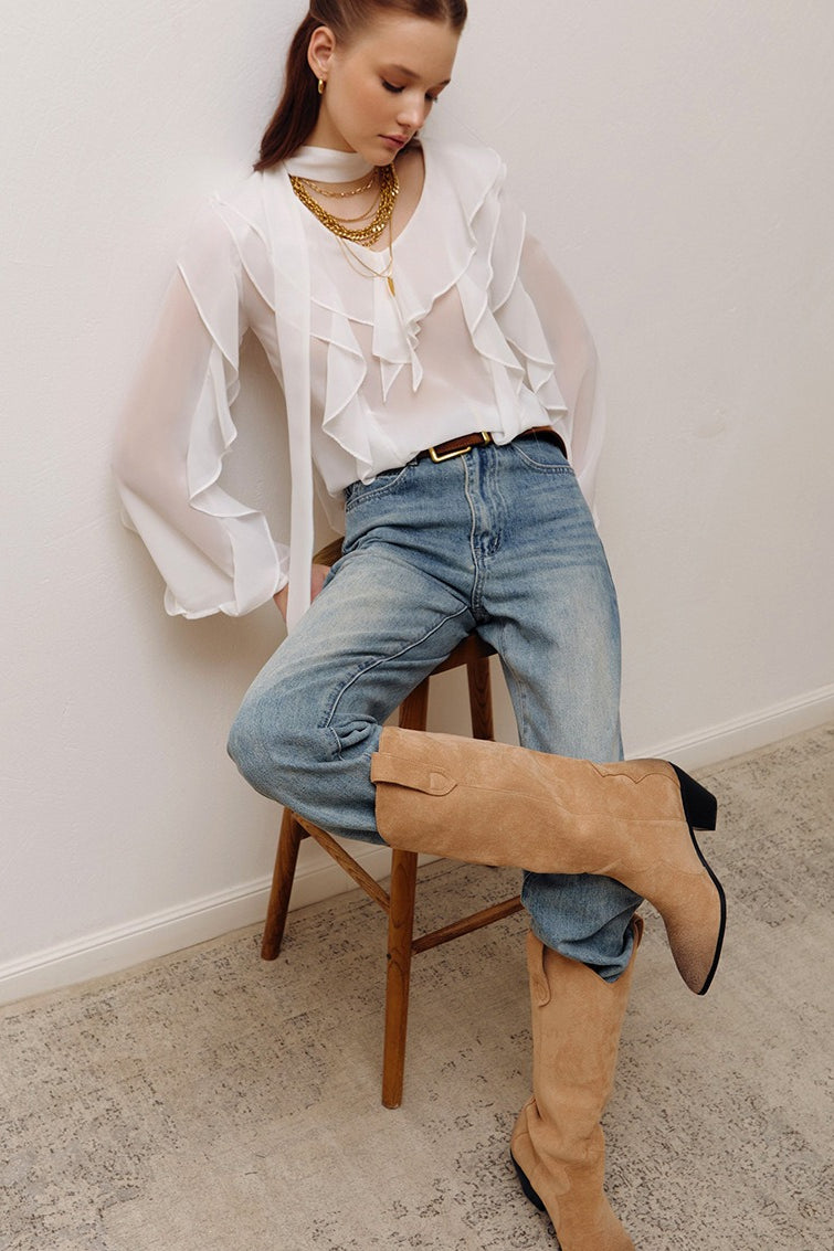 Side view showing the drape and ruffle detail of the blouse
