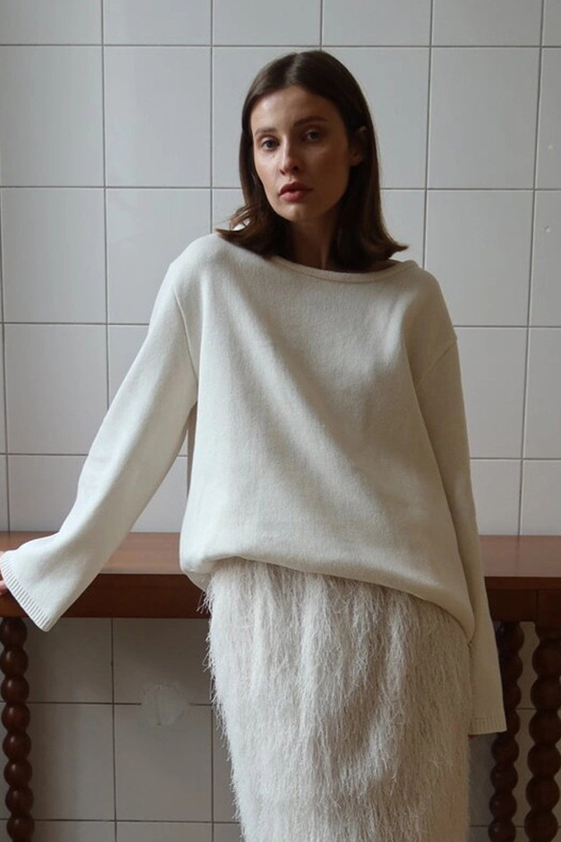 Side view of an open-back knit sweater with long sleeves