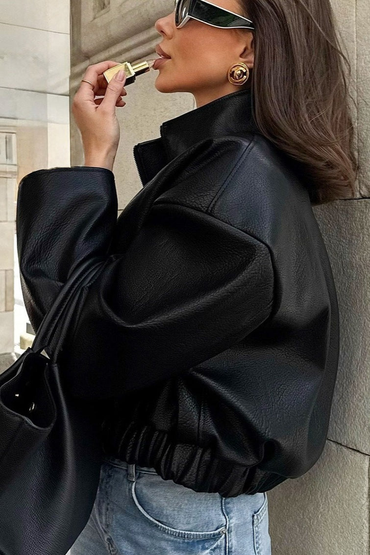 Side view of a cropped faux leather jacket highlighting its short length and fitted silhouette