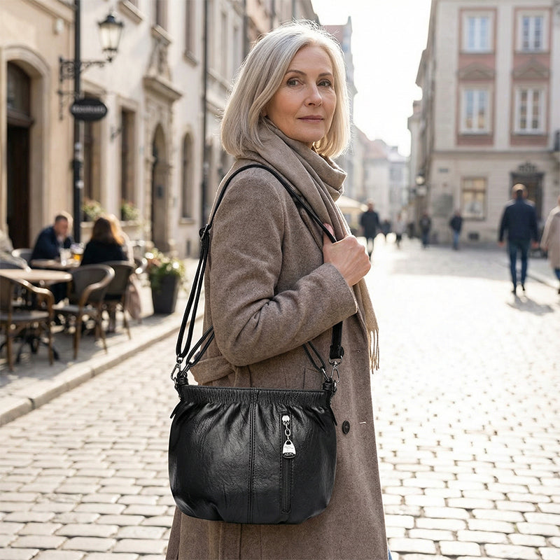 Interior view of women's shoulder bag showing organized storage compartments