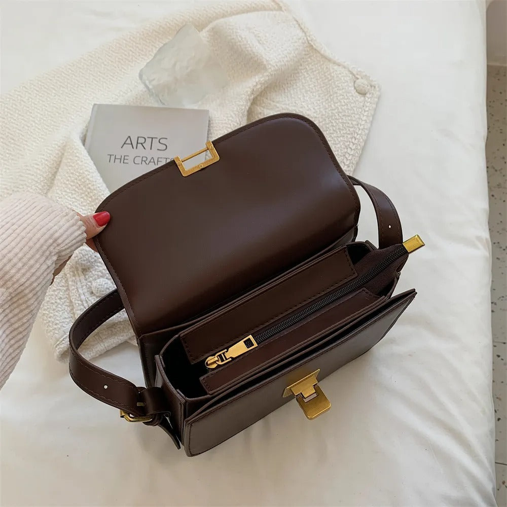 Elegant leather shoulder bag for women displayed at an angled front view