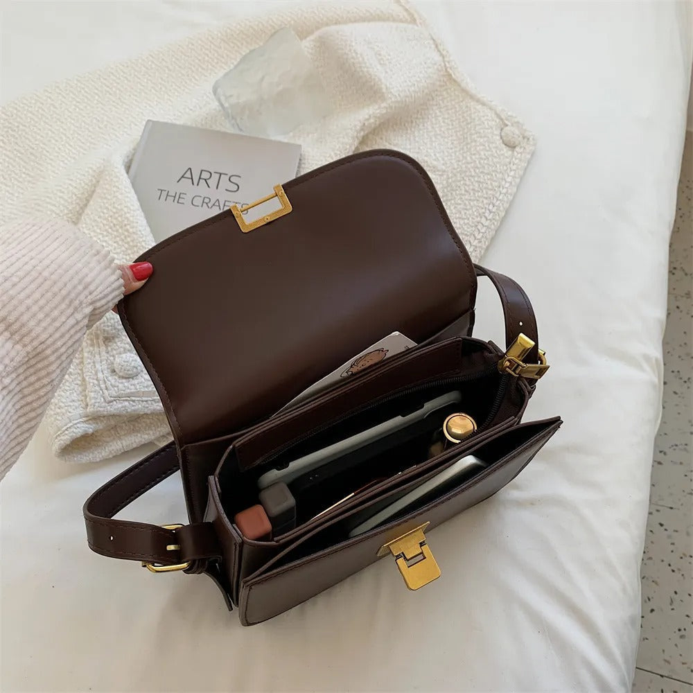 Side view of the women's leather shoulder bag with shoulder strap detail