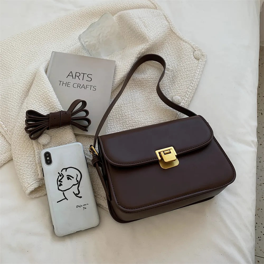 Close-up of the leather texture and hardware on the shoulder bag