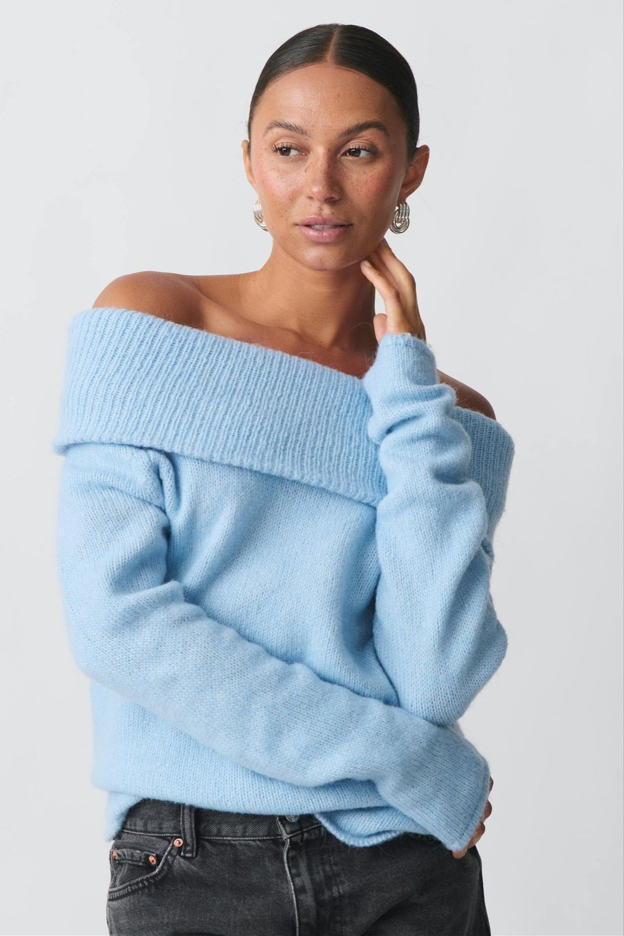 Detail view of the sweater knit texture and foldover collar