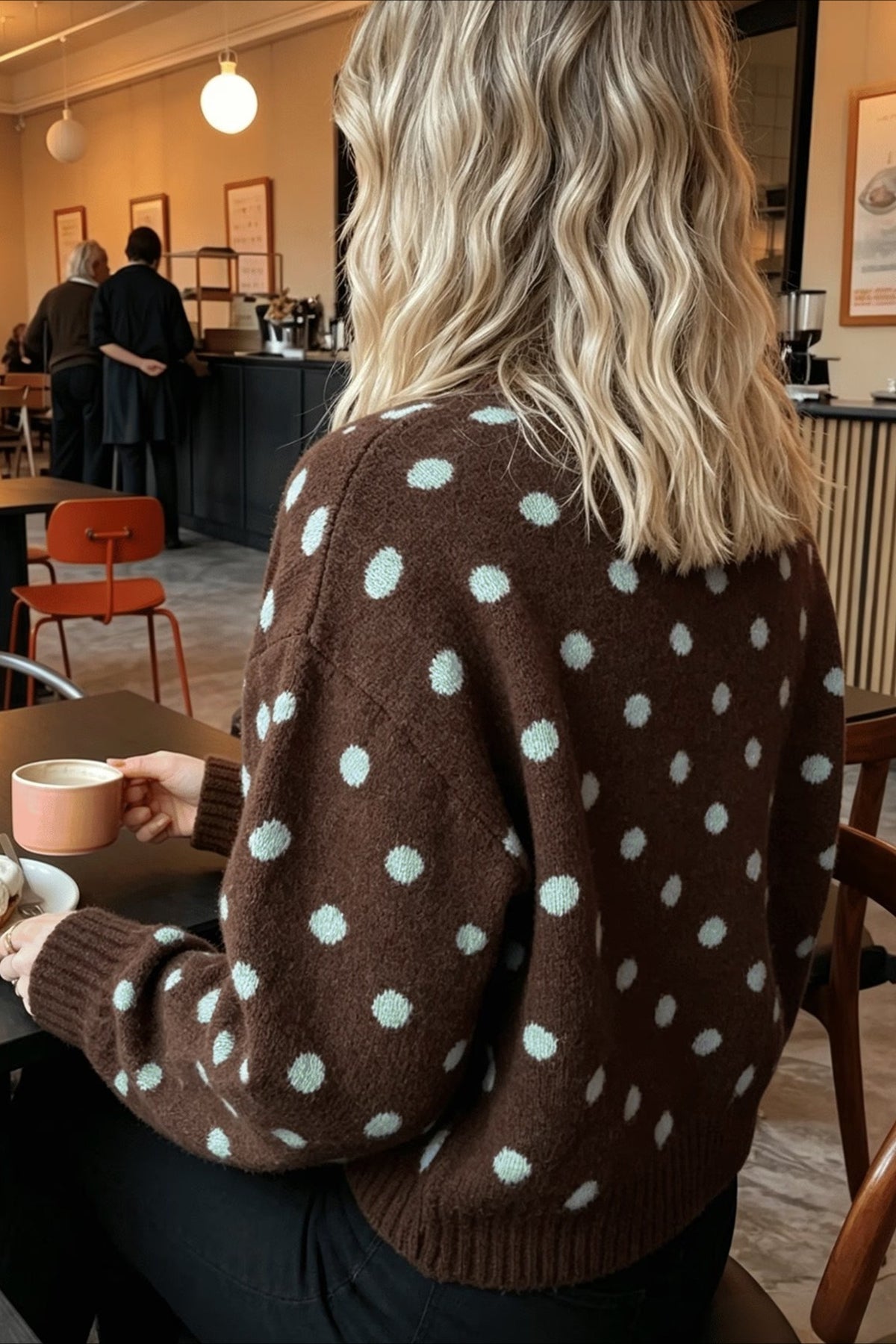 Front view of a brown crew neck sweater with polka dot knit pattern