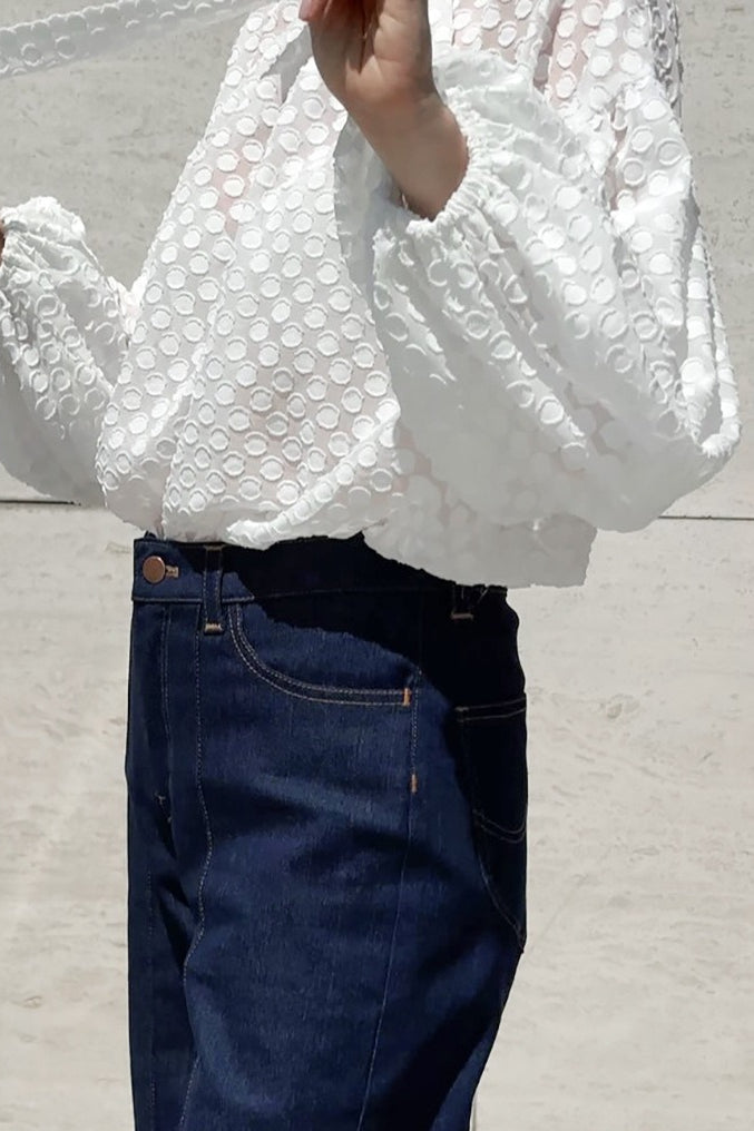 White tie neck blouse featuring voluminous balloon sleeves
