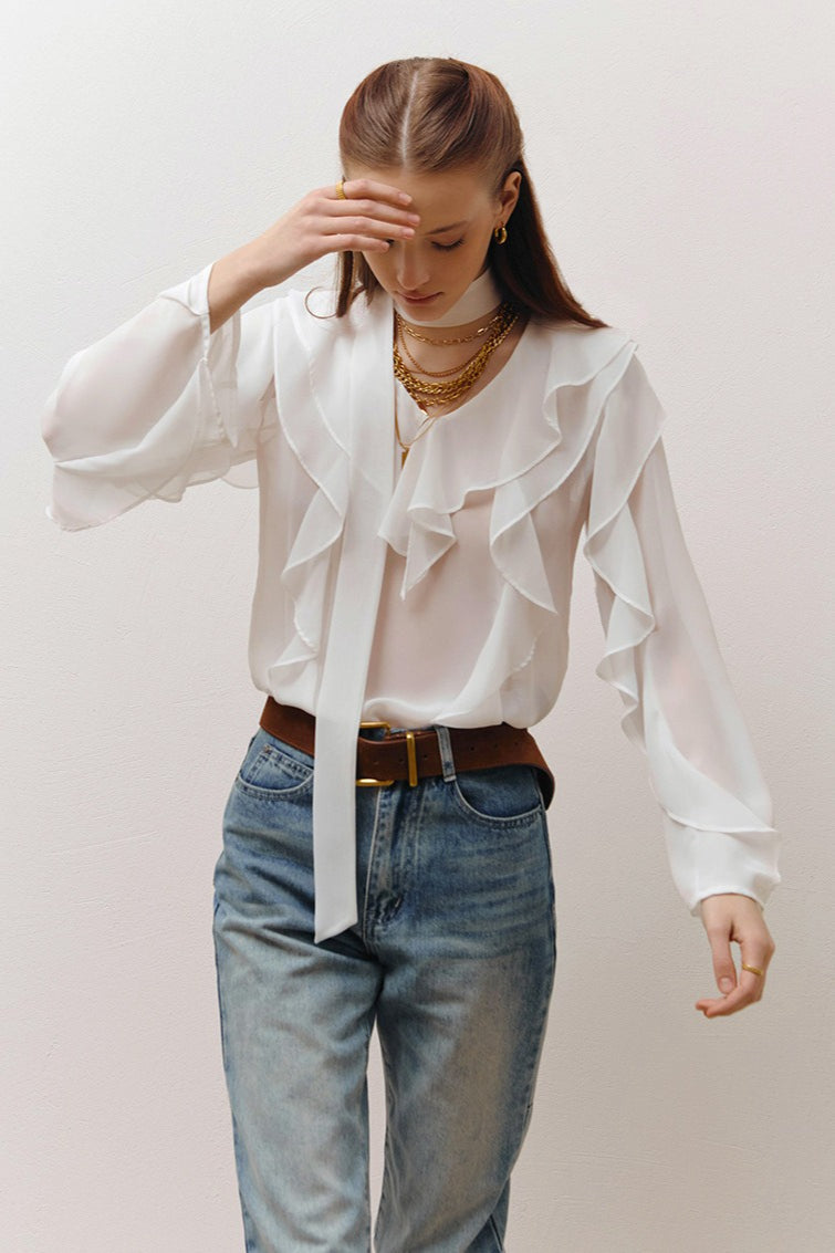 Removable scarf tie attached to the neckline of a ruffle front blouse