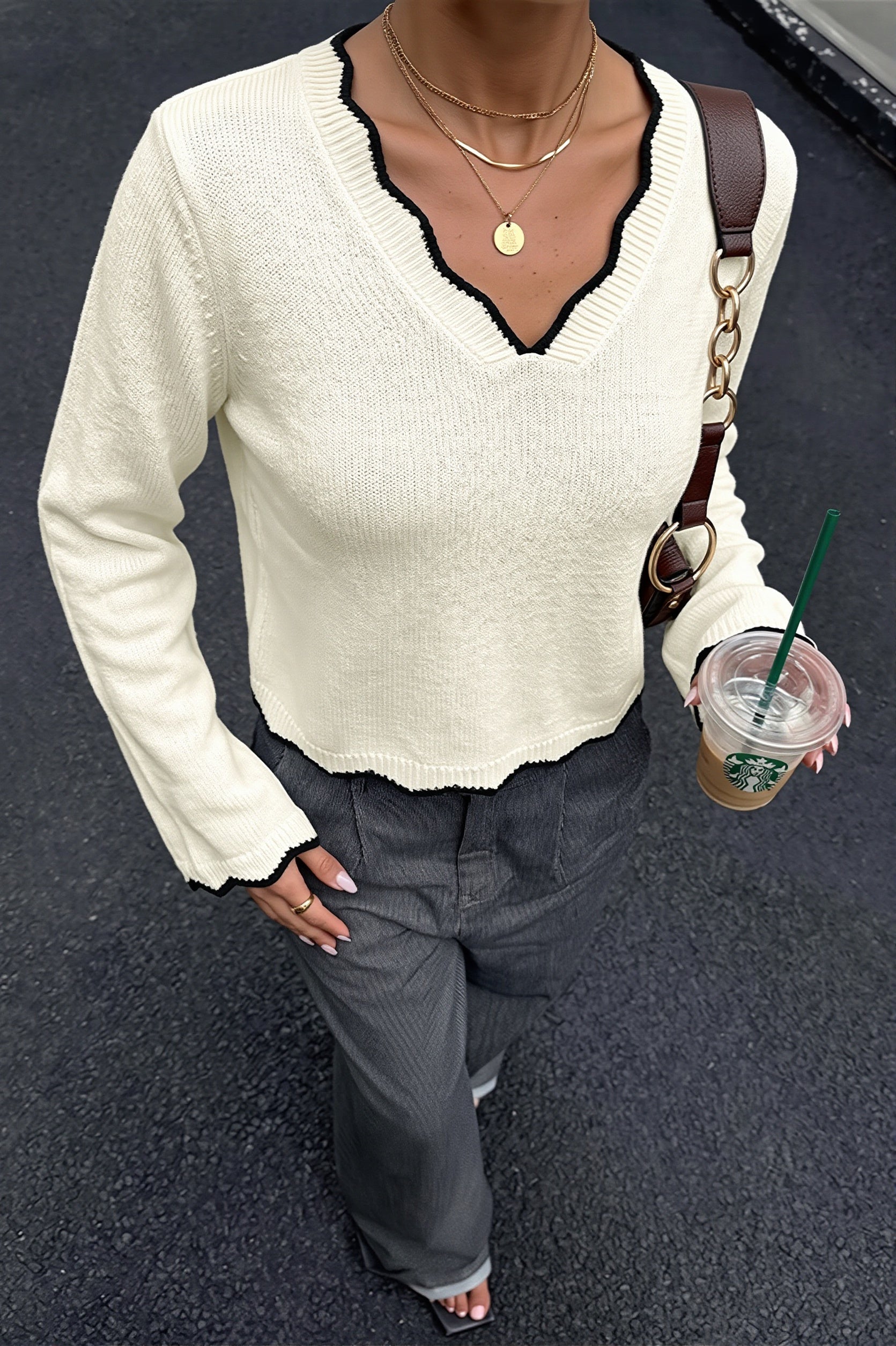 Close-up of the scalloped V-neck and contrast knit detail