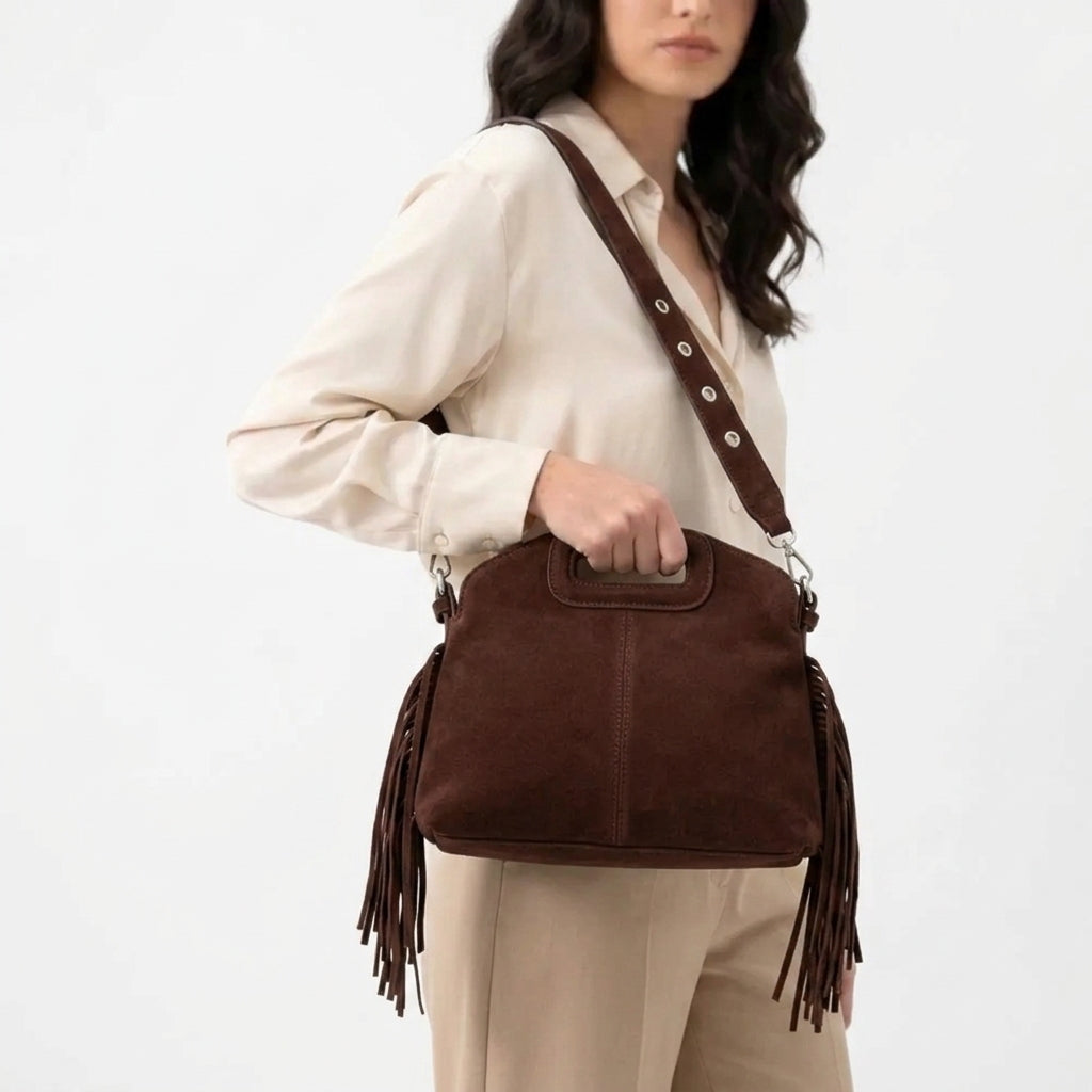 Compact boho-style crossbody bag with tassel fringe accents