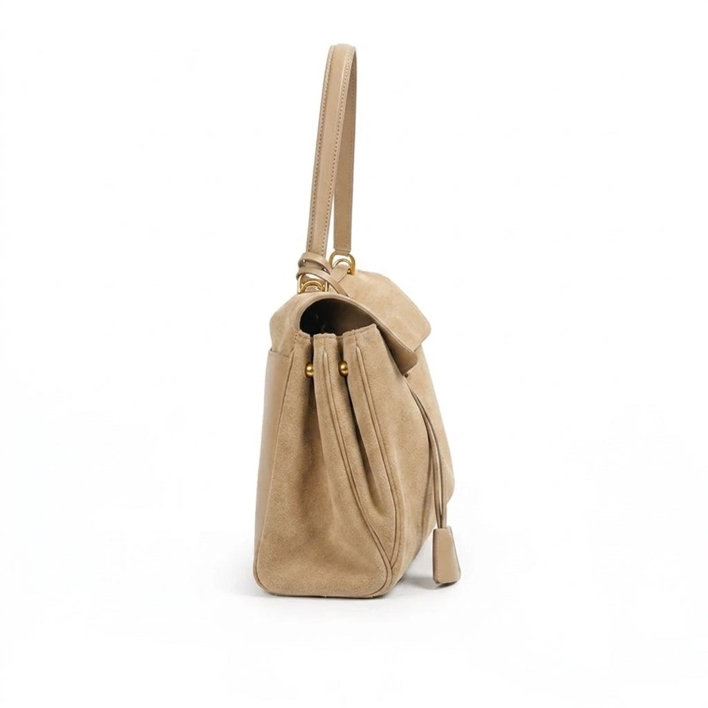 Close-up of the large beige suede tote bag highlighting its soft texture and chic design