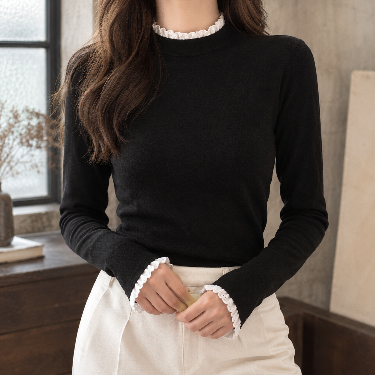 Lace trim mock neck top shown from the front
