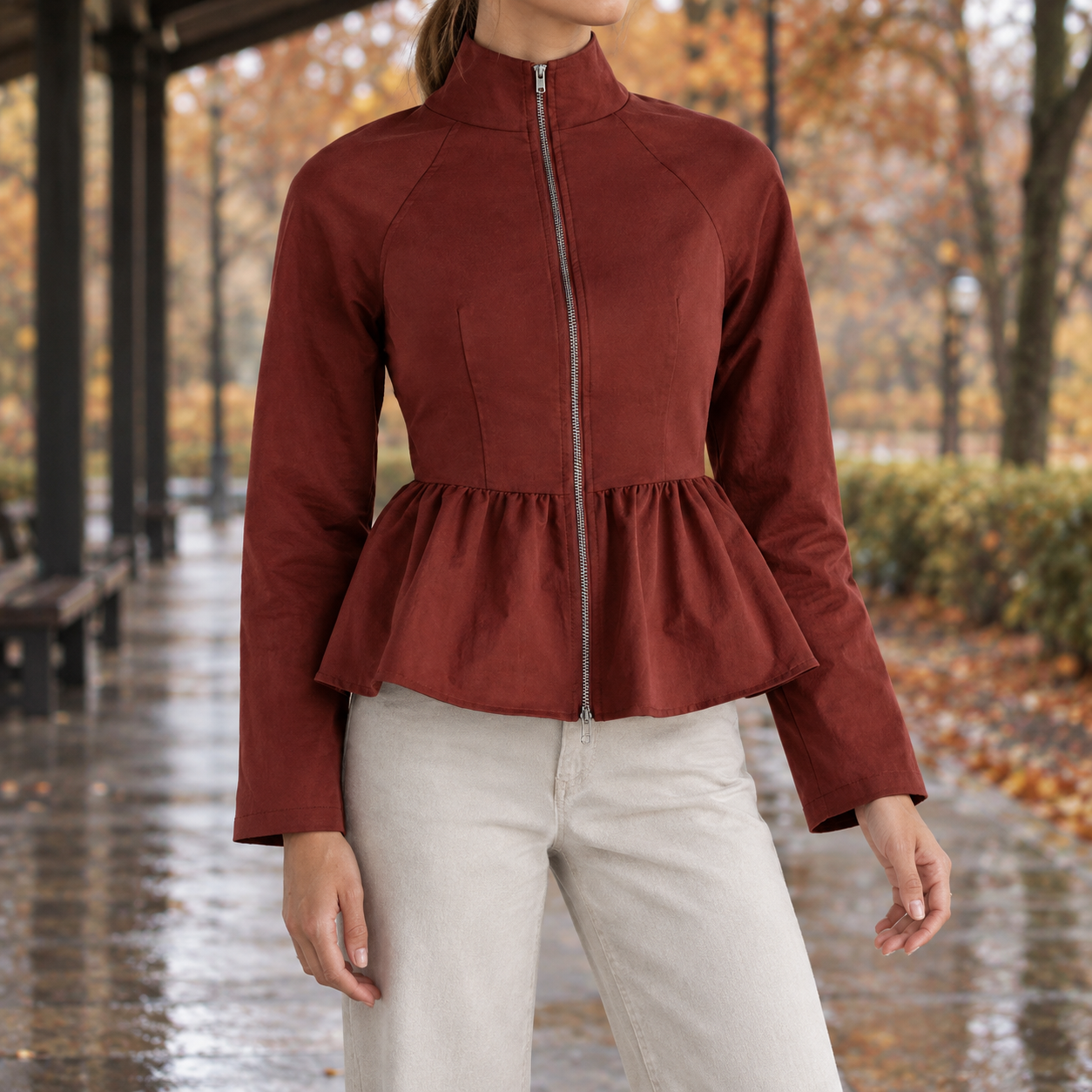 Women's peplum jacket shown from the front with a full-zip closure and waist-defining silhouette