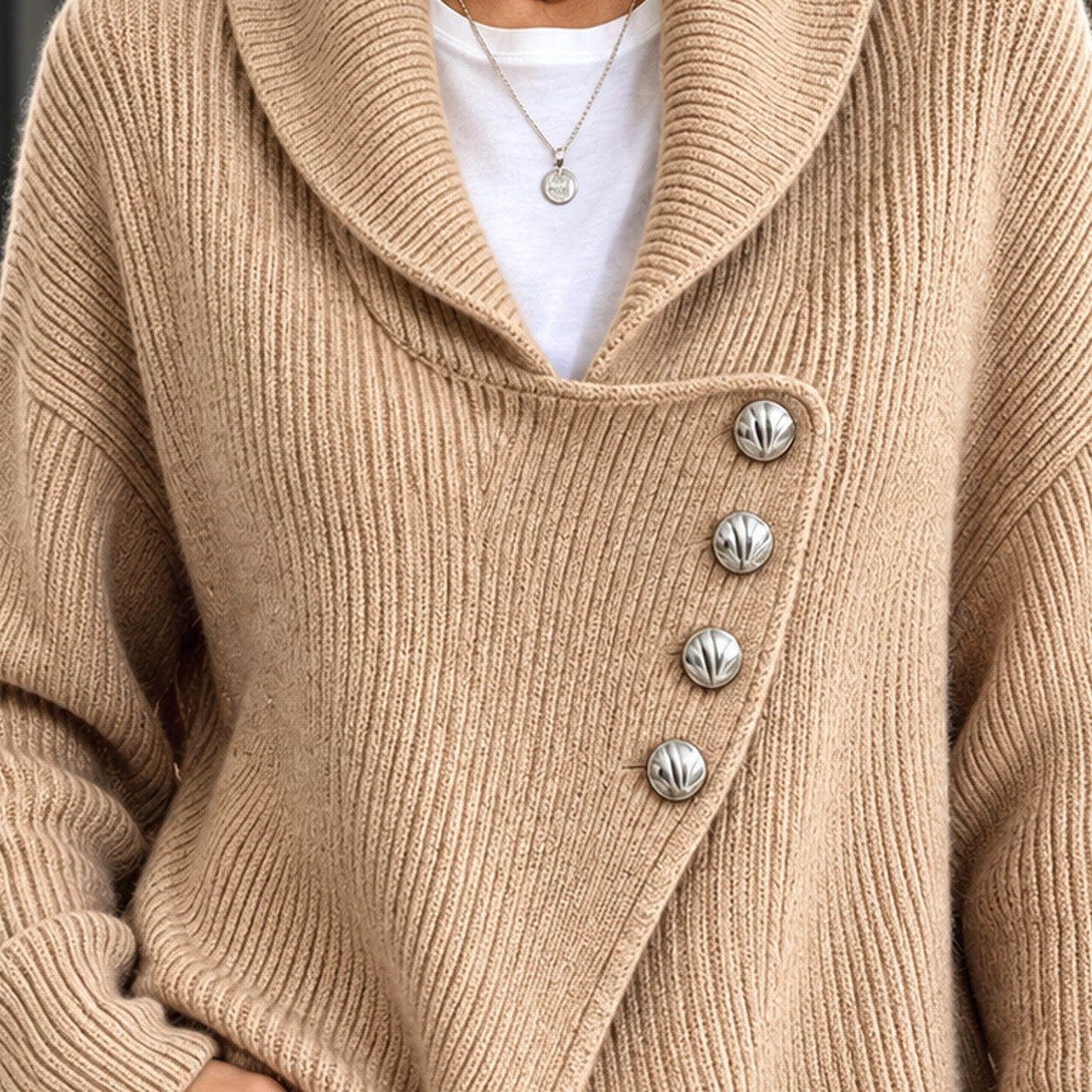 Angled view showing the cardigan’s asymmetric hem and textured knit construction