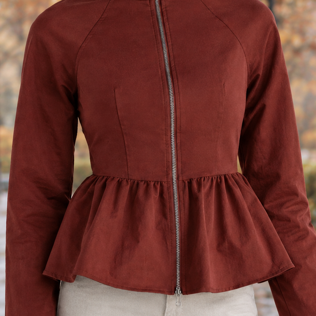 Women's peplum jacket displayed at an angle, highlighting its tailored shape and full-zip front