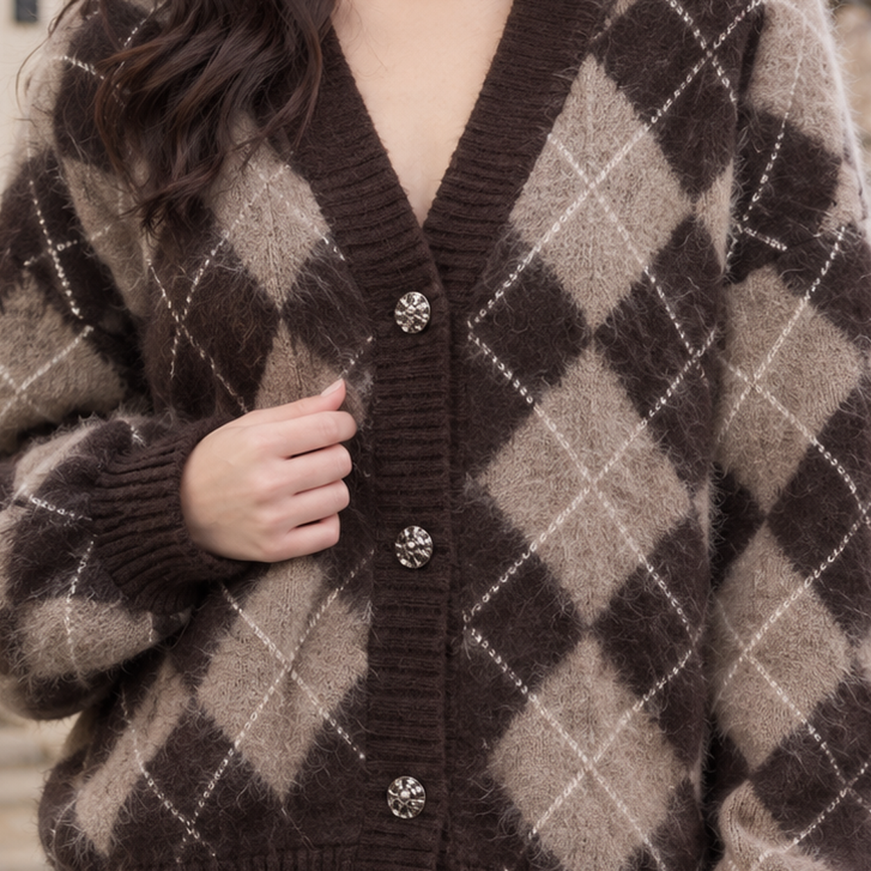 Close-up of the argyle knit texture and button front on the cardigan