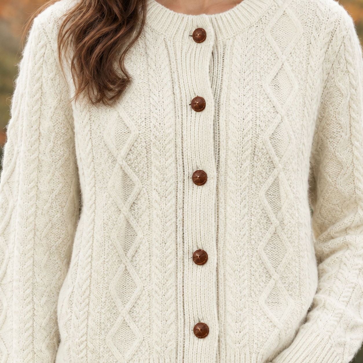 Front view of a wool cable knit cardigan sweater with button closure