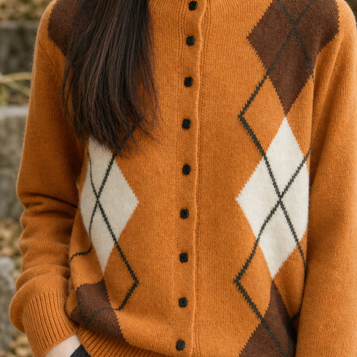 Close-up of the cardigan's mock neck and textured argyle knit pattern