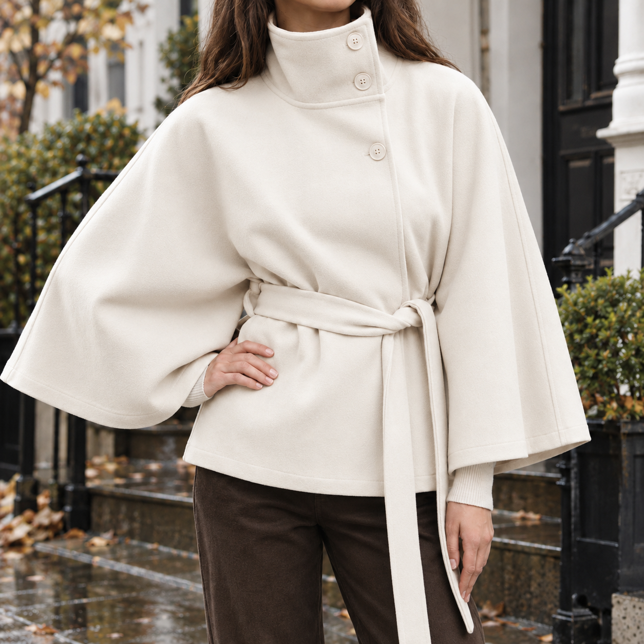 Close-up of the cape jacket's stand collar and tie belt