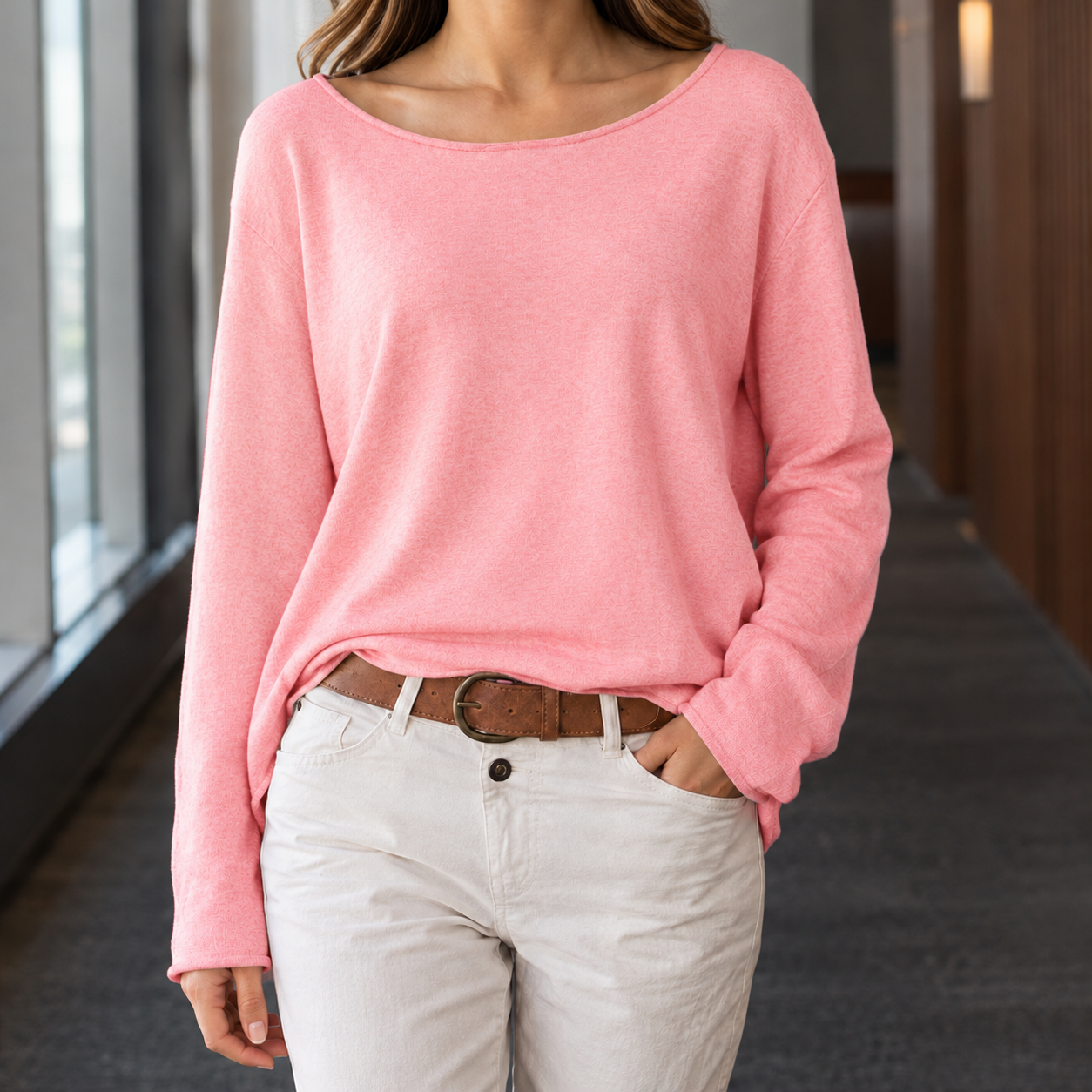 Close-up of the boat neck and long sleeve design on a women's top