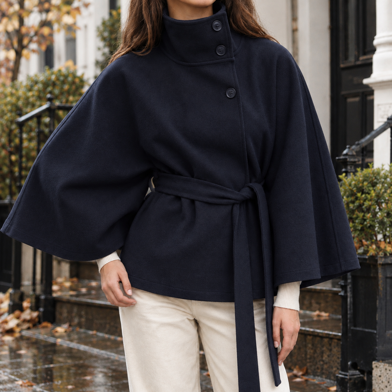 Back view of the cape jacket with its elegant draped design