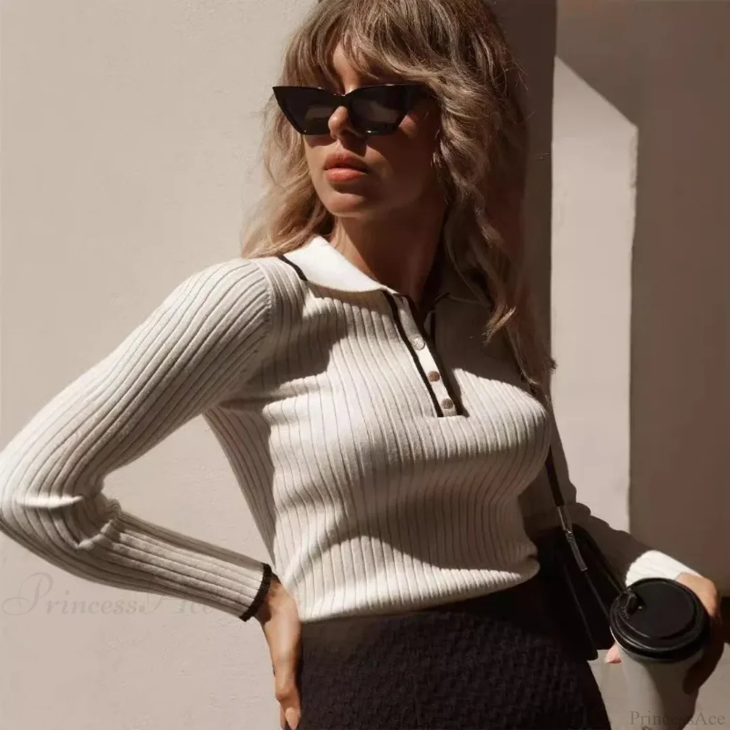 Detail view of the sweater’s long sleeves and knit construction.