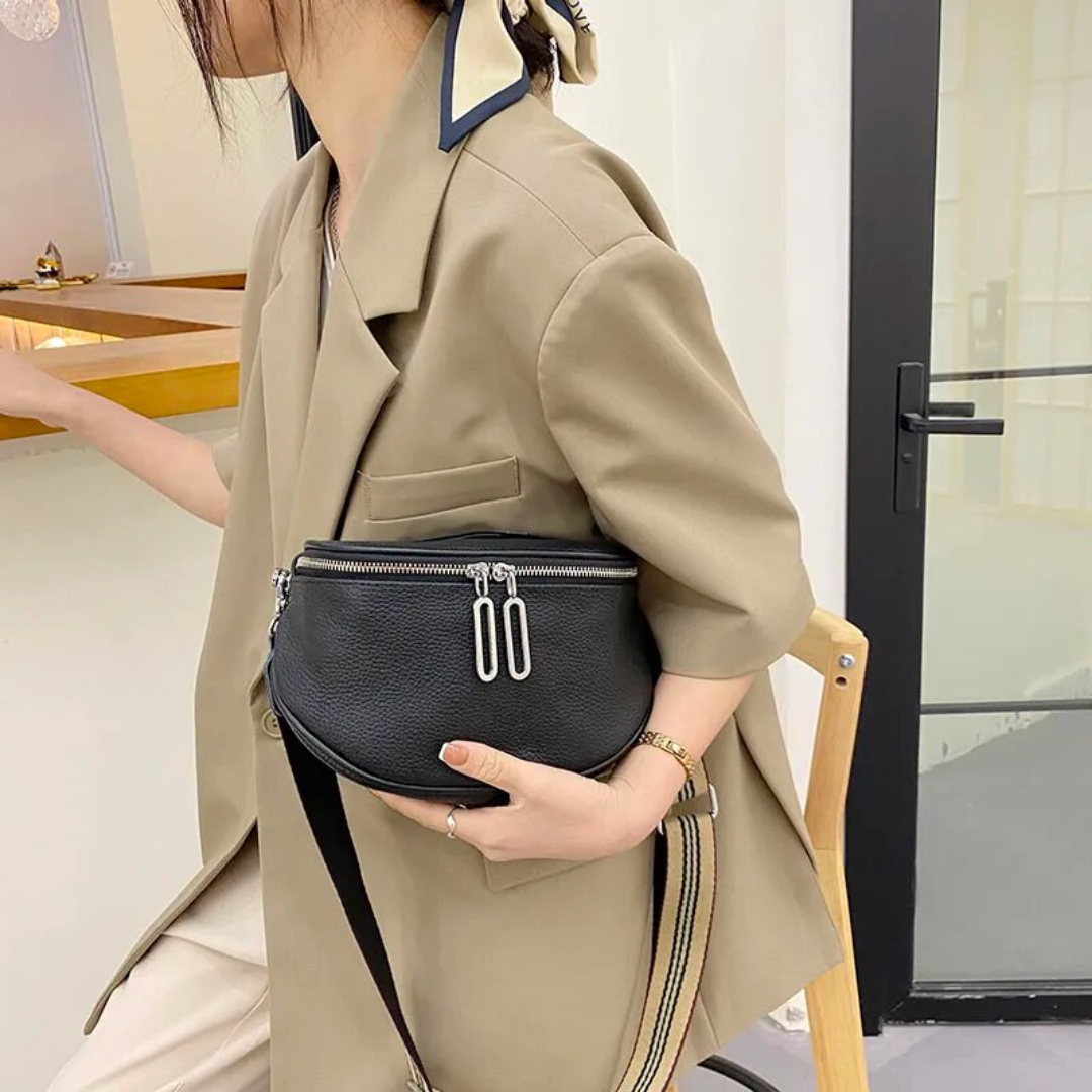 Open compact leather saddle bag showing the interior storage space
