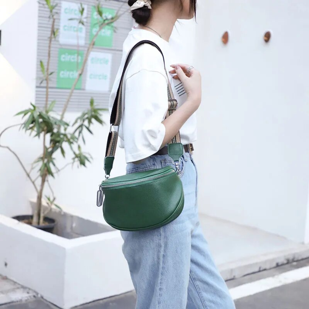 Compact leather saddle bag displayed at a slight angle showing the front and side