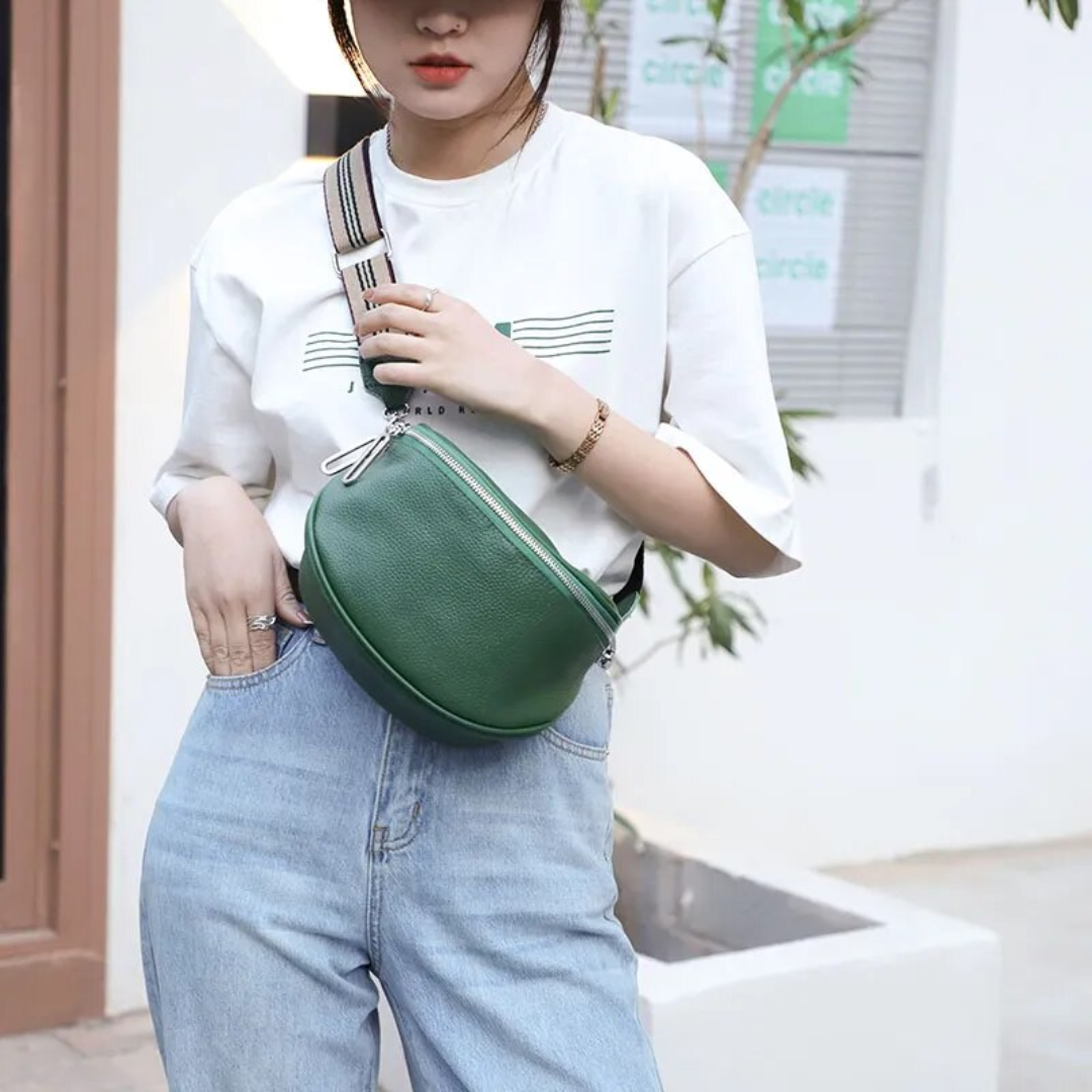 Compact leather saddle bag shown from the front with a structured curved flap