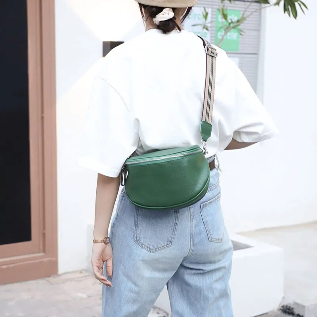Side view of the compact leather saddle bag highlighting its curved silhouette