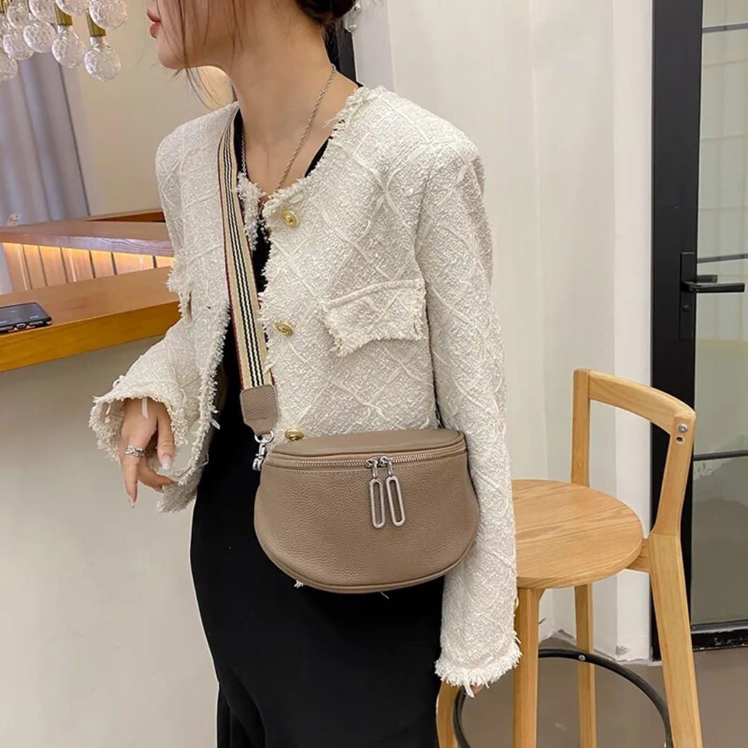 Compact leather saddle bag displayed in a lifestyle setting for daily essentials